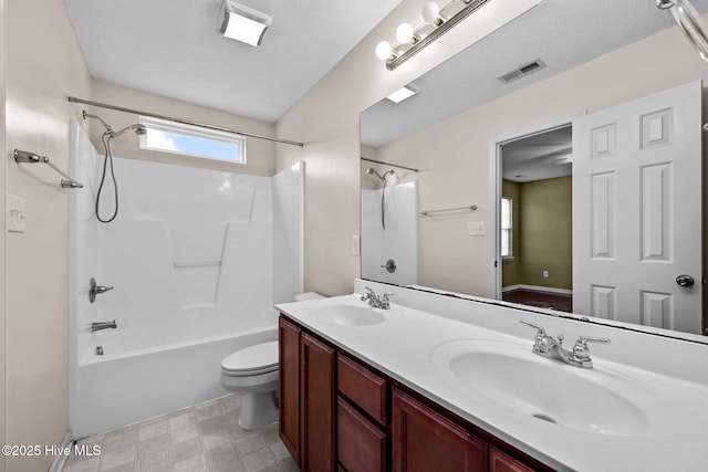 bathroom with toilet, washtub / shower combination, visible vents, and a sink