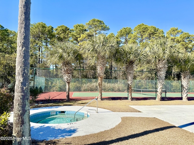 view of pool featuring fence and a hot tub