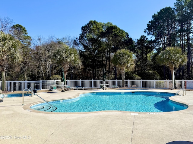 community pool featuring a patio and fence