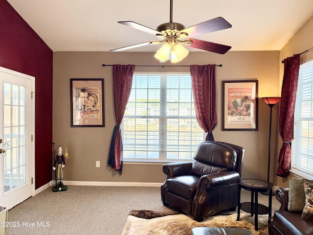 sitting room featuring plenty of natural light, baseboards, and carpet