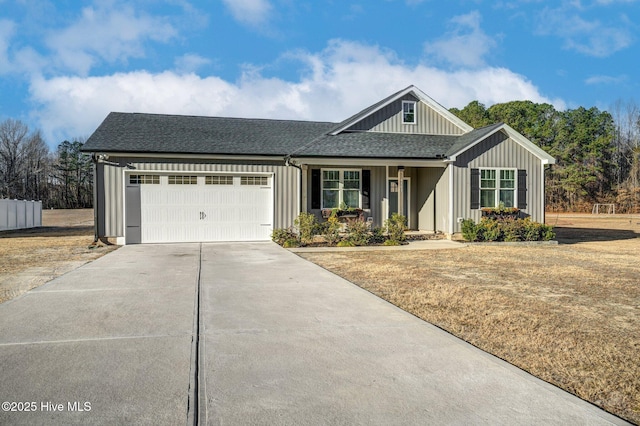 view of front of property with board and batten siding, concrete driveway, roof with shingles, and a garage