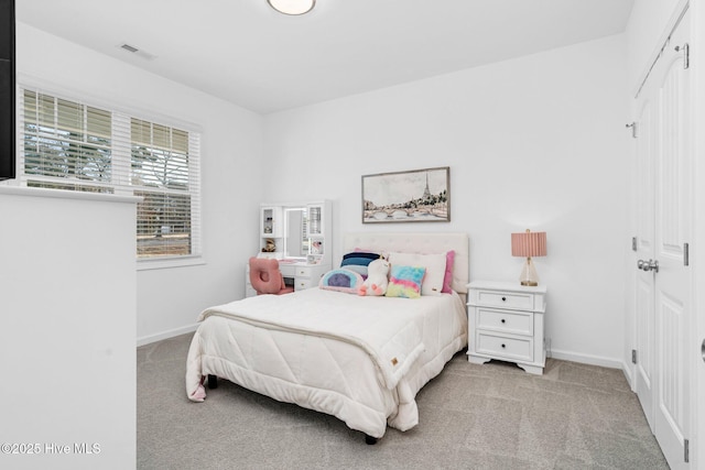 bedroom featuring light carpet, baseboards, and visible vents