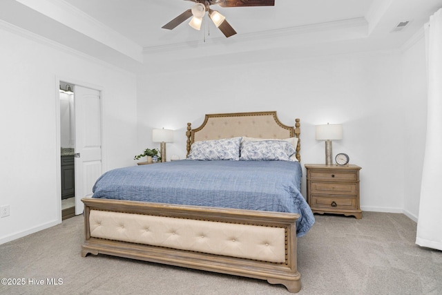 bedroom featuring baseboards, crown molding, a tray ceiling, and carpet flooring