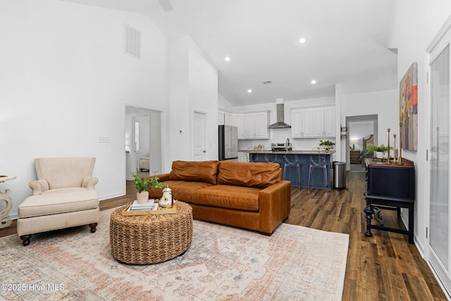 living room with wood finished floors, plenty of natural light, a glass covered fireplace, and baseboards