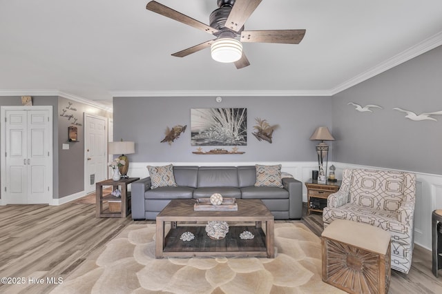 living room with ceiling fan, light hardwood / wood-style floors, and ornamental molding