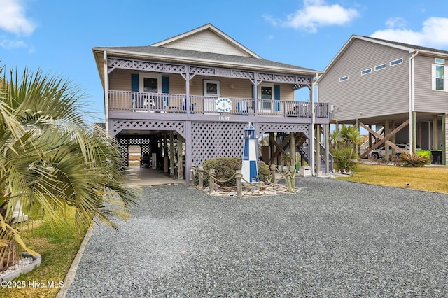 view of front of house featuring a porch and a carport