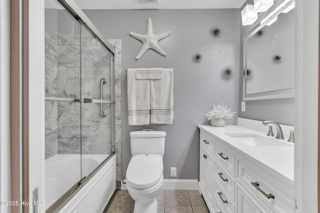 full bathroom with toilet, vanity, tile patterned flooring, and shower / bath combination with glass door