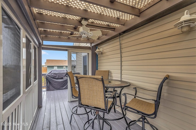 sunroom / solarium with ceiling fan and beamed ceiling