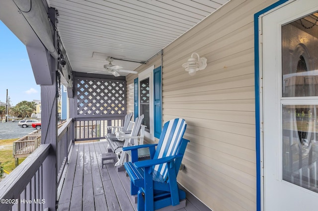 wooden deck with ceiling fan and a porch