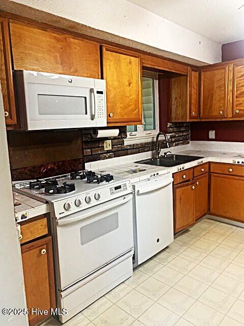 kitchen with sink and white appliances