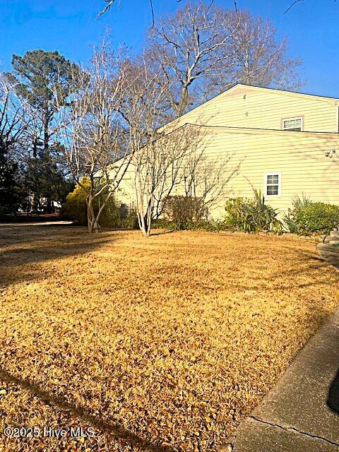 view of side of home featuring a lawn