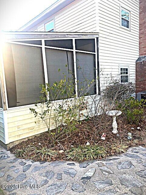 view of side of property with a sunroom