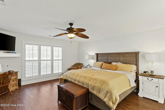 bedroom featuring crown molding, dark hardwood / wood-style floors, and ceiling fan