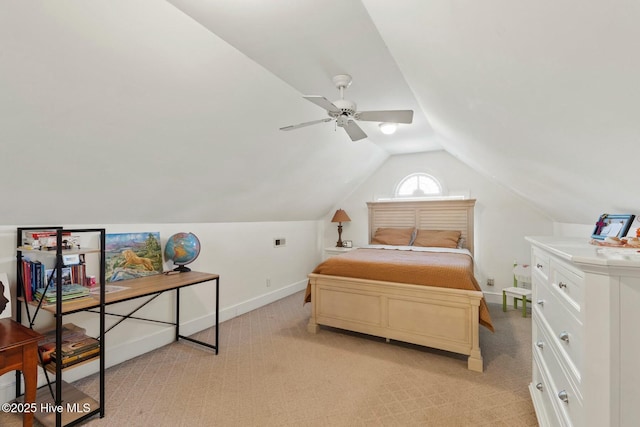 bedroom featuring light colored carpet and lofted ceiling