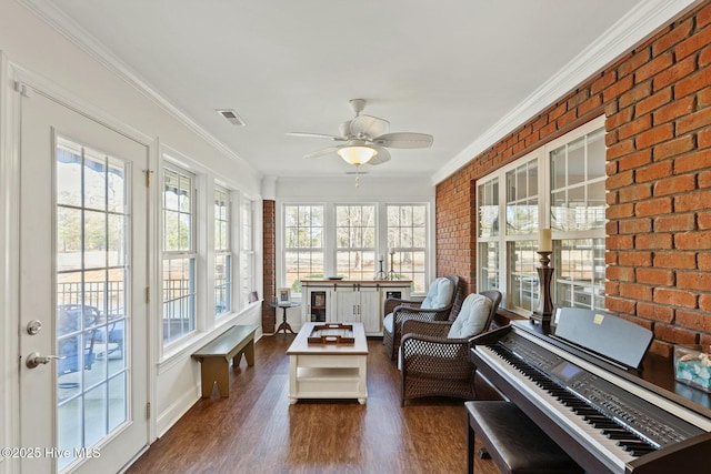 sunroom / solarium featuring ceiling fan and plenty of natural light