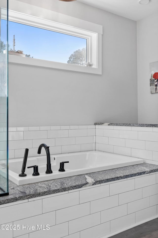 bathroom with tiled bath