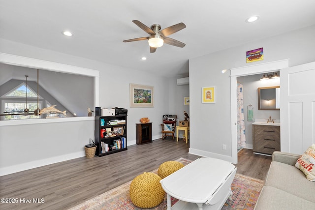 living room with sink, dark wood-type flooring, and ceiling fan