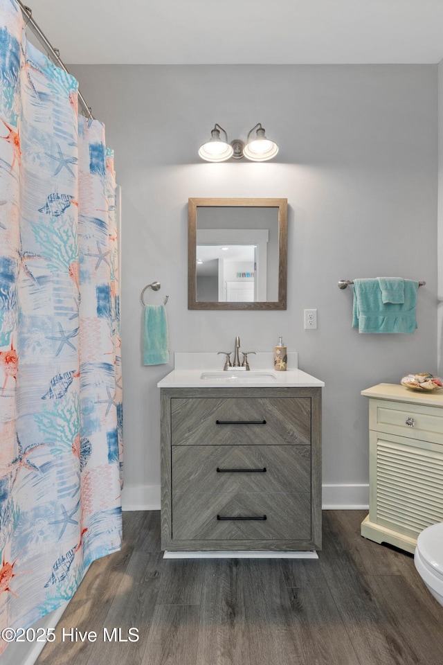 bathroom featuring hardwood / wood-style floors, toilet, and vanity