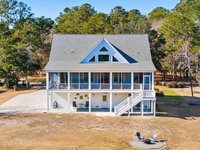 back of property with a patio area and a fire pit