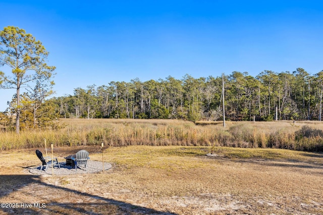 view of yard with an outdoor fire pit