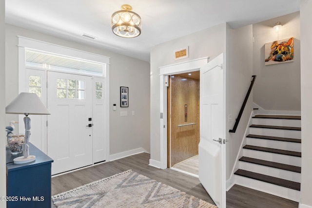 foyer entrance featuring dark hardwood / wood-style floors