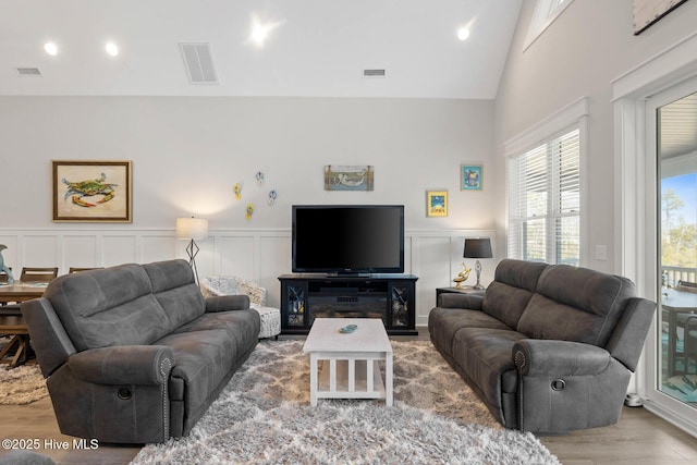 living room featuring vaulted ceiling and hardwood / wood-style floors