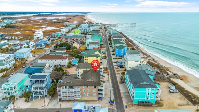 birds eye view of property with a water view and a view of the beach