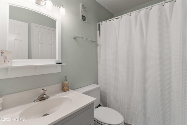 1503 Carolina Beach Ave N Unit 1D, Carolina Beach, NC 28428 - bathroom with vanity, toilet, and a shower with shower curtain