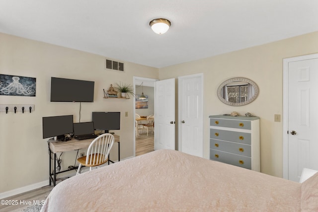 1503 Carolina Beach Ave N Unit 1D, Carolina Beach, NC 28428 - bedroom featuring wood finished floors, baseboards, and a desk