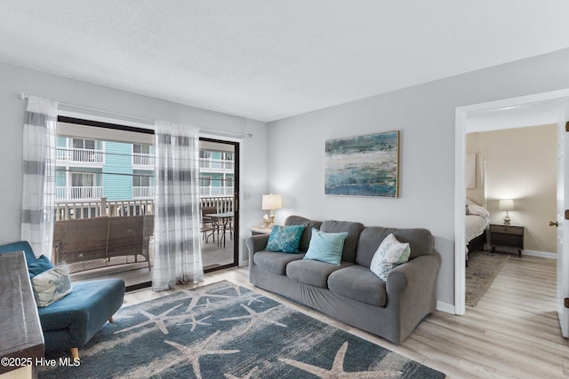 living room featuring a textured ceiling and light hardwood / wood-style floors