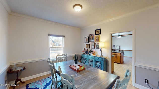 dining area featuring ornamental molding, a textured ceiling, and light hardwood / wood-style floors