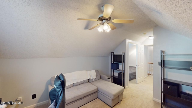 living room featuring ceiling fan, light colored carpet, vaulted ceiling, and a textured ceiling