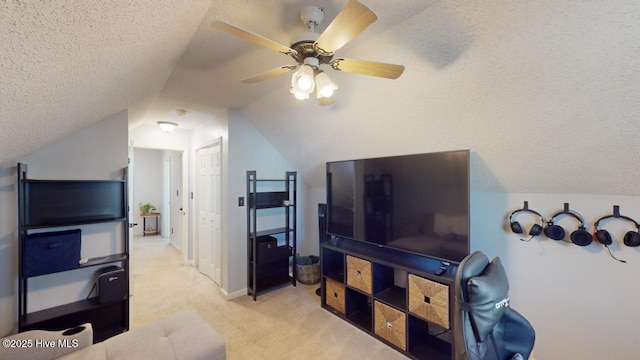carpeted living room with ceiling fan, lofted ceiling, and a textured ceiling