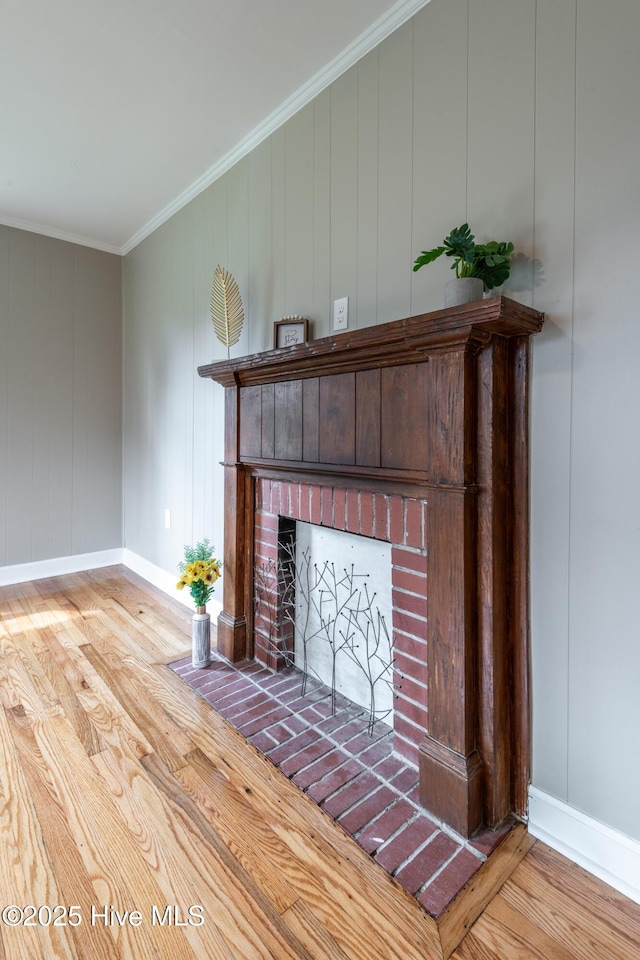 interior details with hardwood / wood-style floors, a fireplace, and ornamental molding