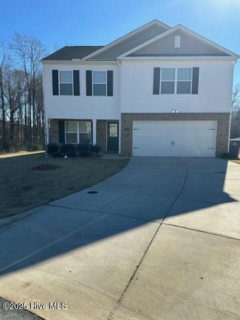 view of front of property featuring driveway and an attached garage