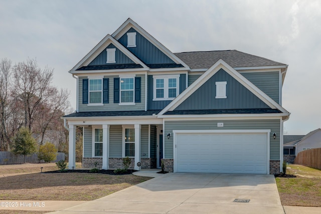 craftsman-style home featuring a porch, a garage, fence, concrete driveway, and board and batten siding