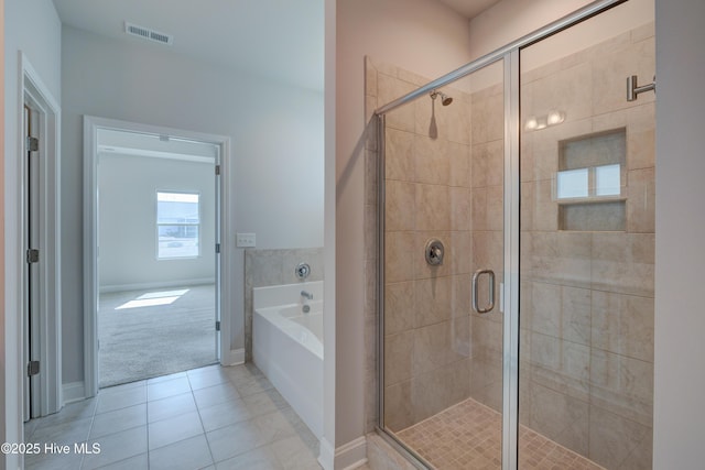 bathroom with a garden tub, a shower stall, visible vents, and tile patterned floors