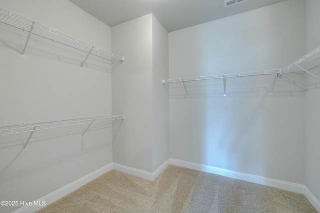 walk in closet featuring carpet flooring and visible vents