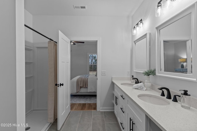 bathroom with toilet, tile patterned flooring, and vanity