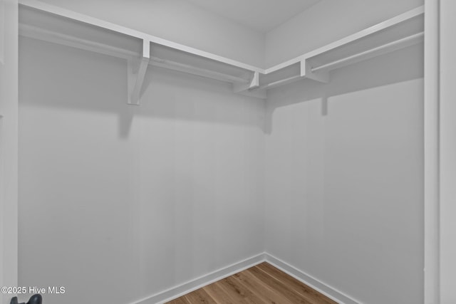 corridor featuring dark wood-style floors and baseboards