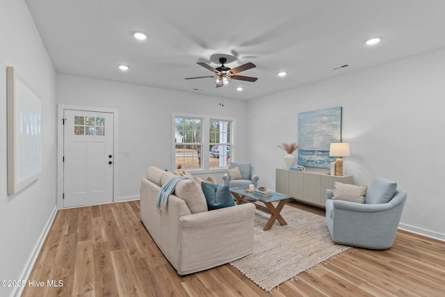 living room with ceiling fan, visible vents, wood finished floors, and recessed lighting