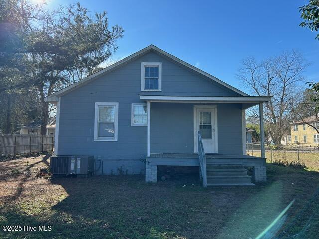 bungalow featuring covered porch and central AC unit