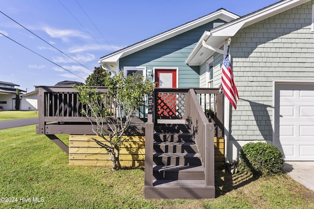 exterior space with a garage and a lawn