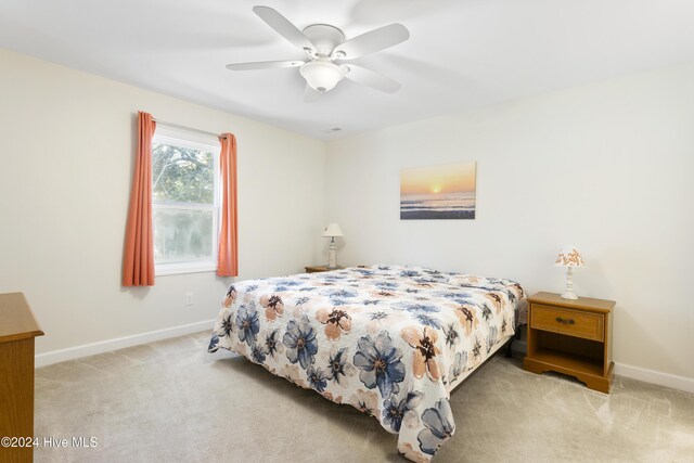 living area featuring ceiling fan and light colored carpet