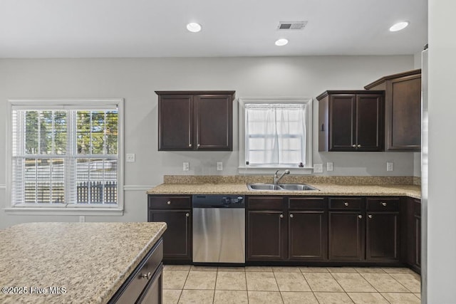 kitchen with light tile patterned floors, sink, dark brown cabinetry, and stainless steel dishwasher