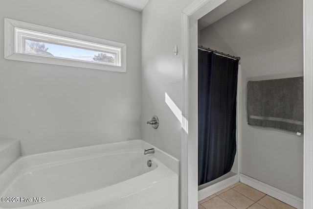 bathroom with tile patterned floors and shower with separate bathtub