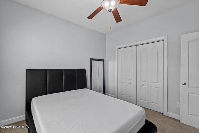 bedroom with ceiling fan, a closet, and carpet floors