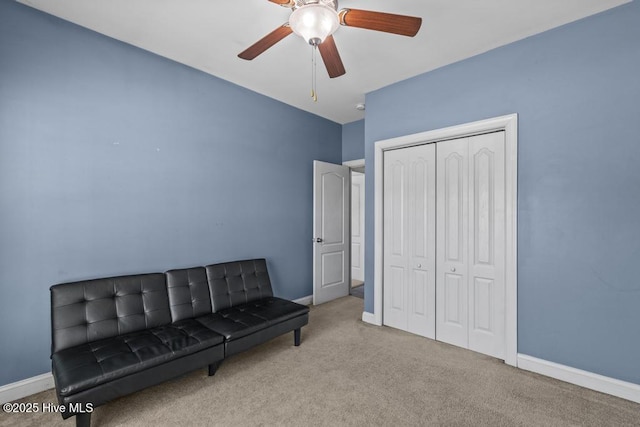 living area featuring ceiling fan and light colored carpet