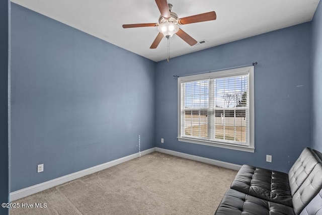 unfurnished room featuring ceiling fan and light colored carpet