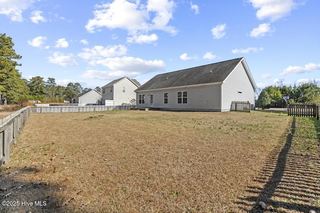 rear view of property with a yard